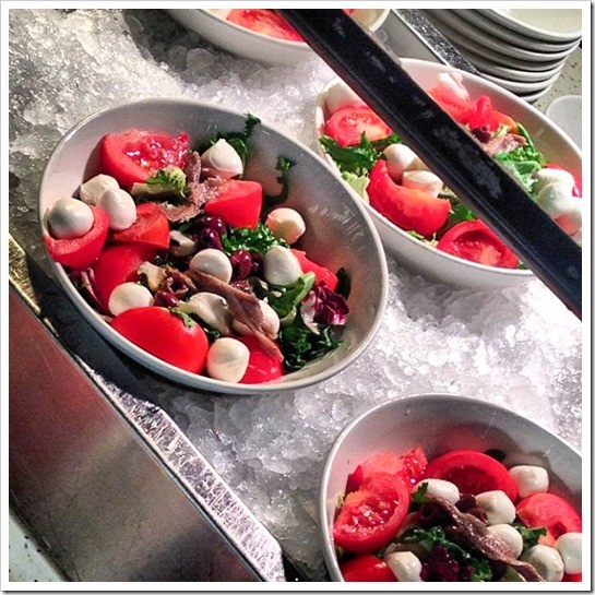 Simple salads with tomatoes, mozzarella balls, greens and anchovies. Delicious